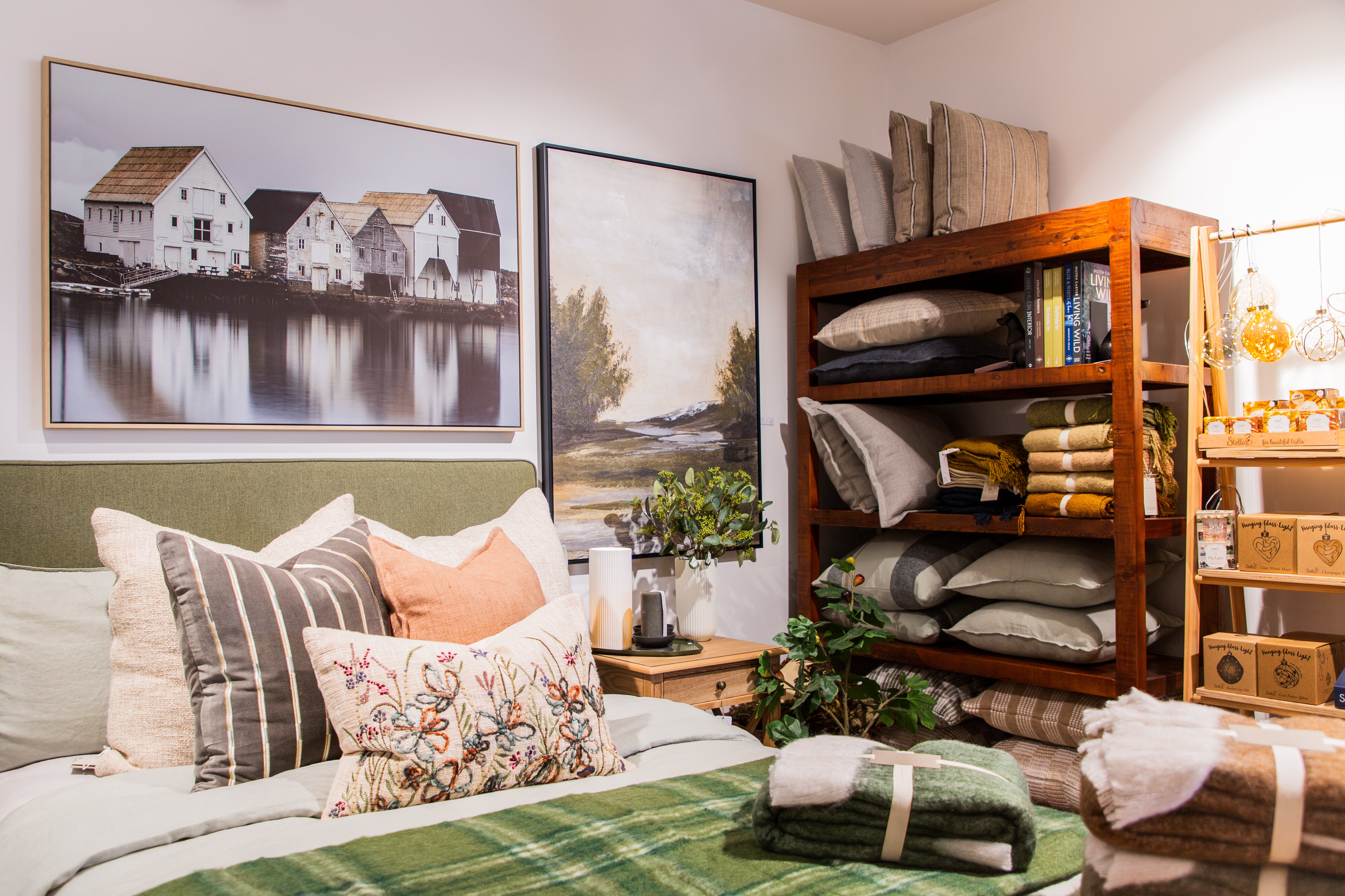 Cozy bedroom with a bed, bookshelf, and wall art